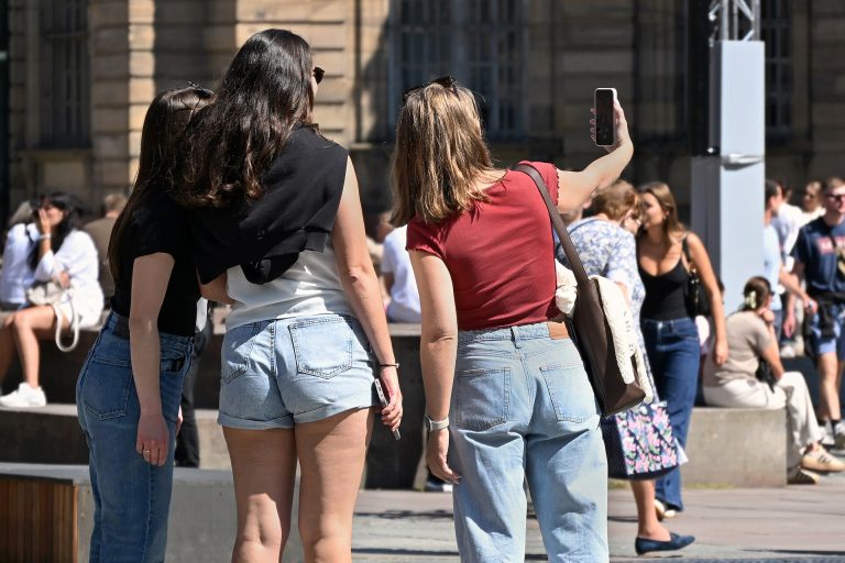 Young Audiences Are Rewriting the Rules of News Young women gathered around a smartphone outdoors, recording and sharing a short video together.